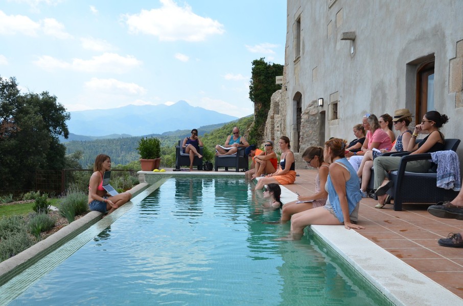 a group of people sitting on a pool
