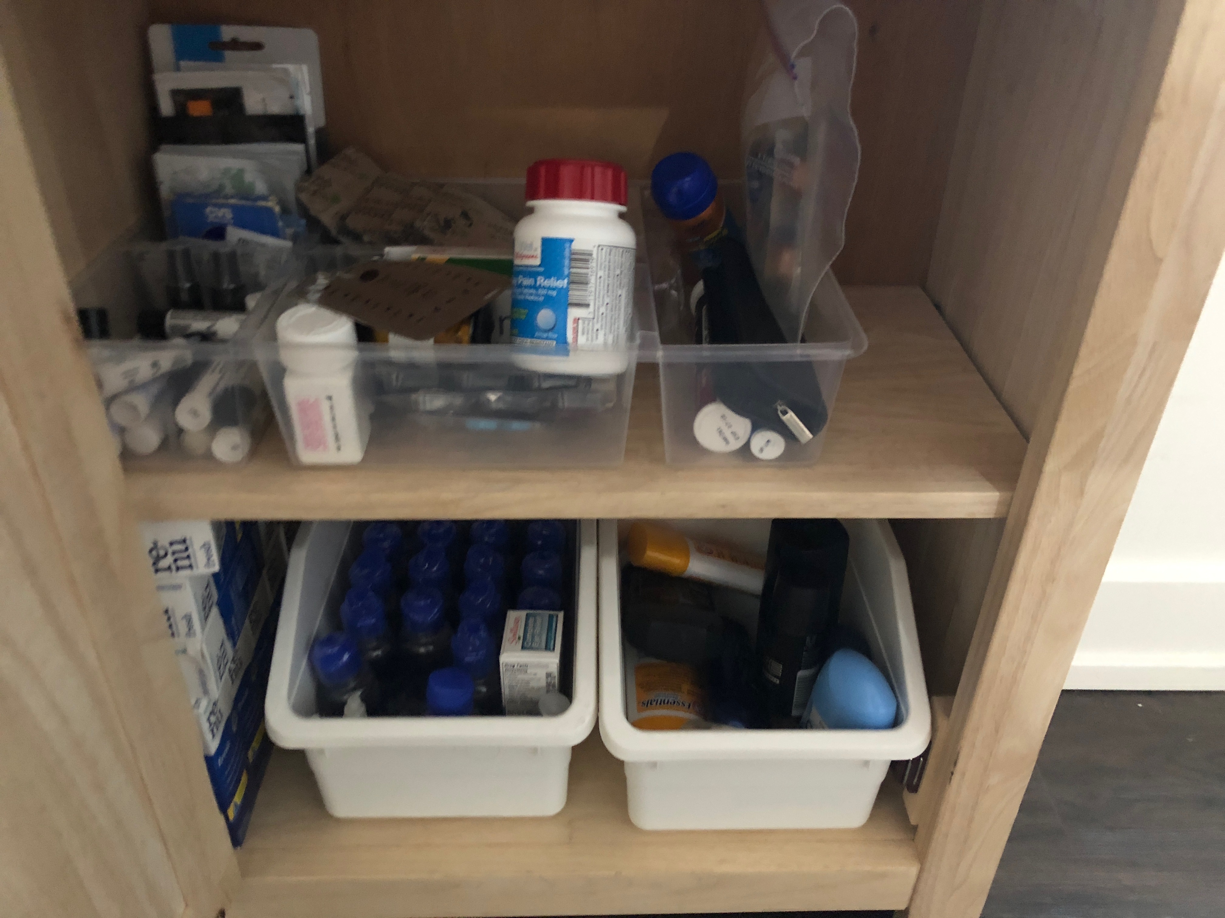 a shelf with containers of medicine and other items