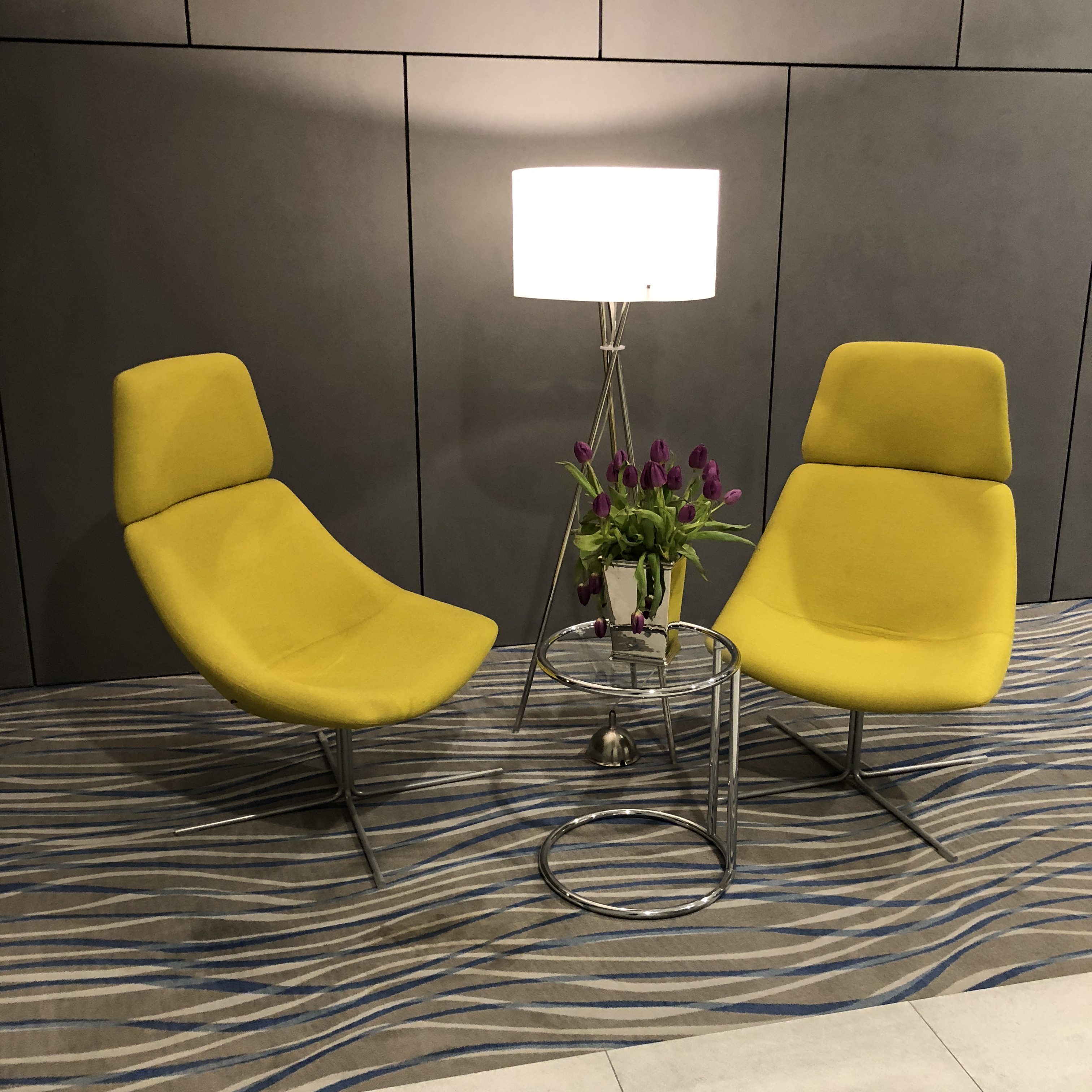 a yellow chairs next to a lamp
