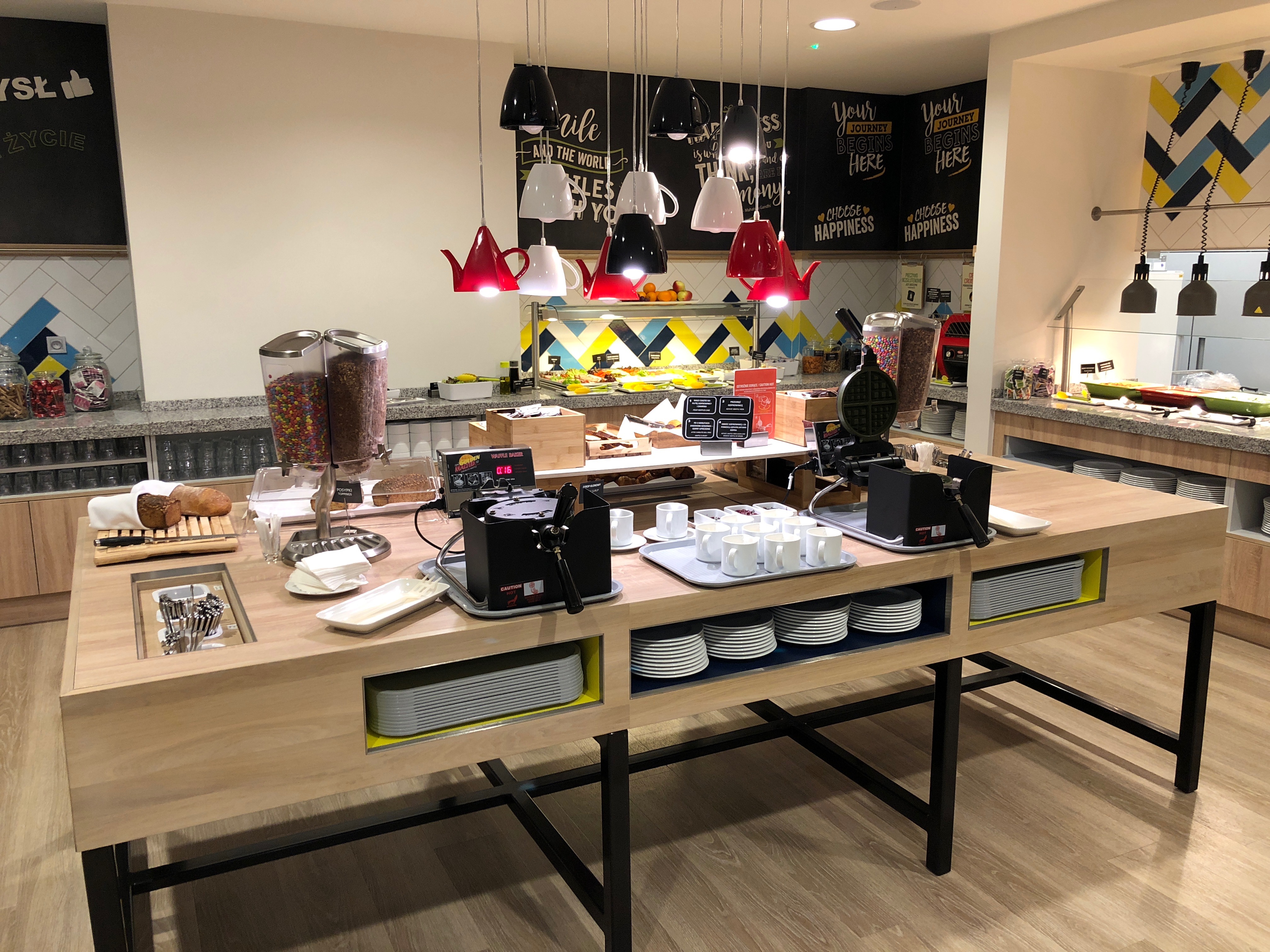 a counter with coffee cups and plates on it