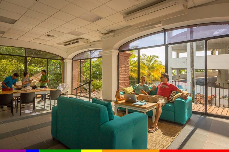 a group of people sitting on couches in a room with windows