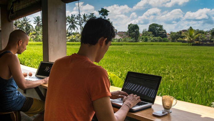 a man sitting at a table with a laptop