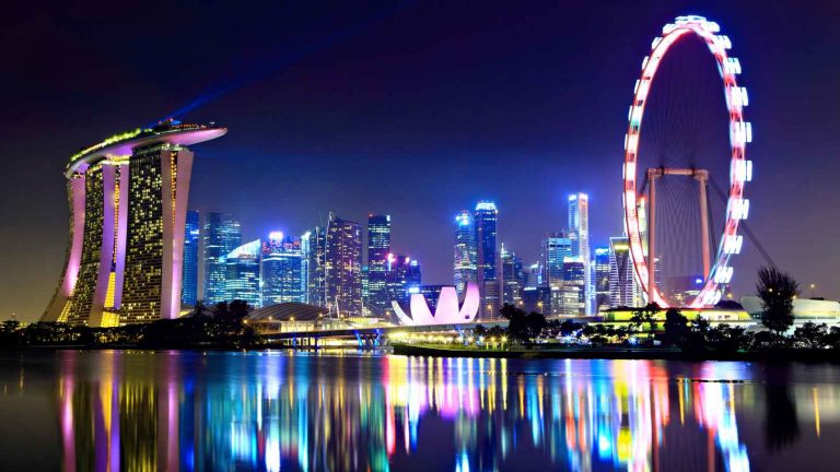 a city skyline with a ferris wheel and a body of water