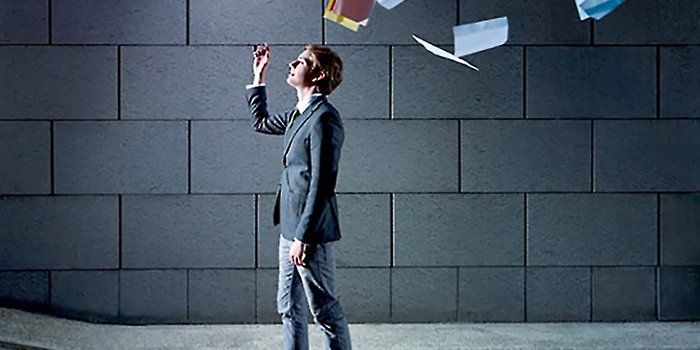 a man throwing papers in the air