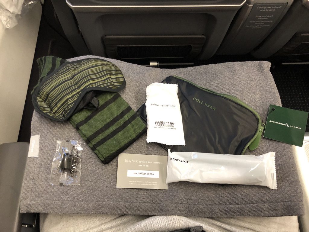 a sleeping bag and eye mask on a seat