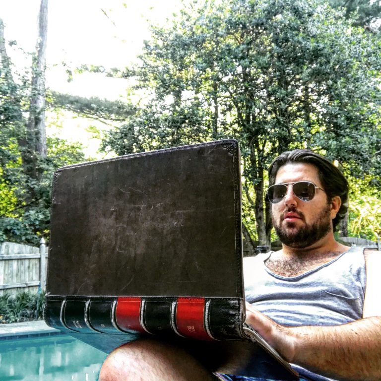 a man sitting in a chair with a laptop