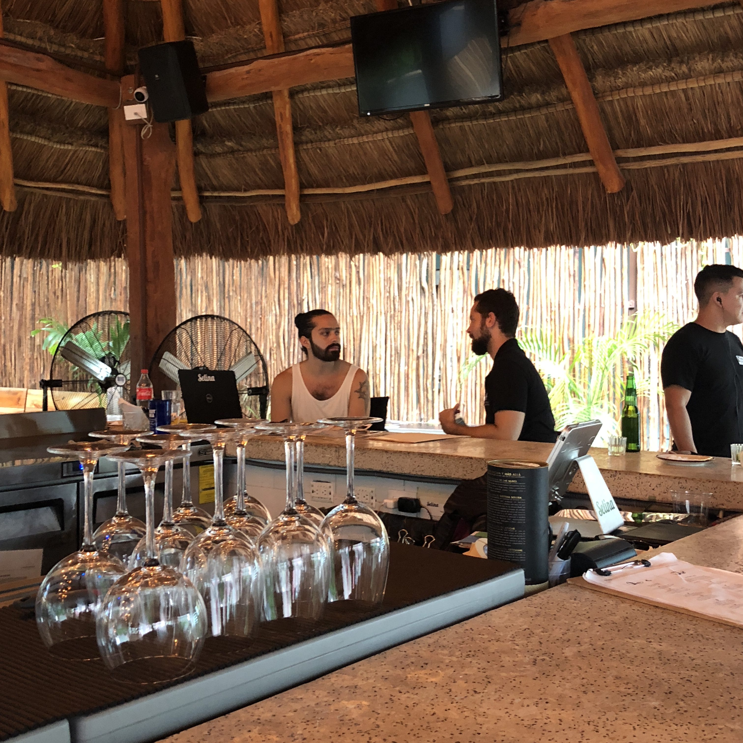 a group of men sitting at a bar