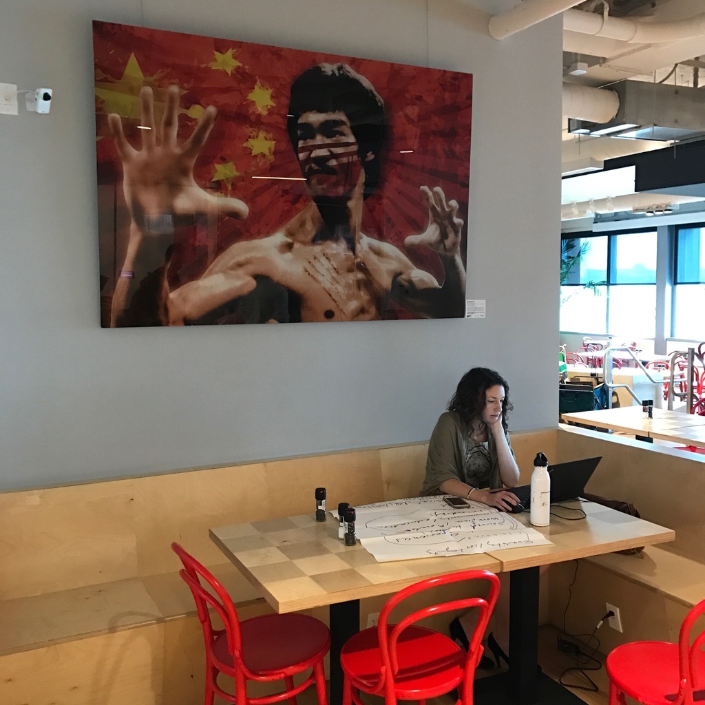 a woman sitting at a table with a laptop