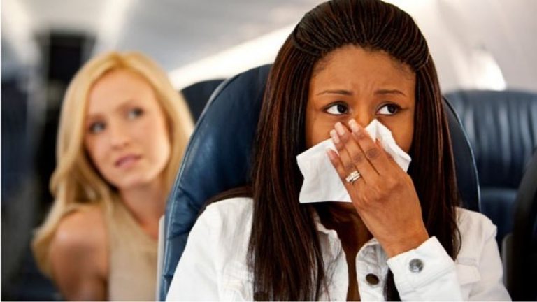 a woman blowing her nose with a napkin