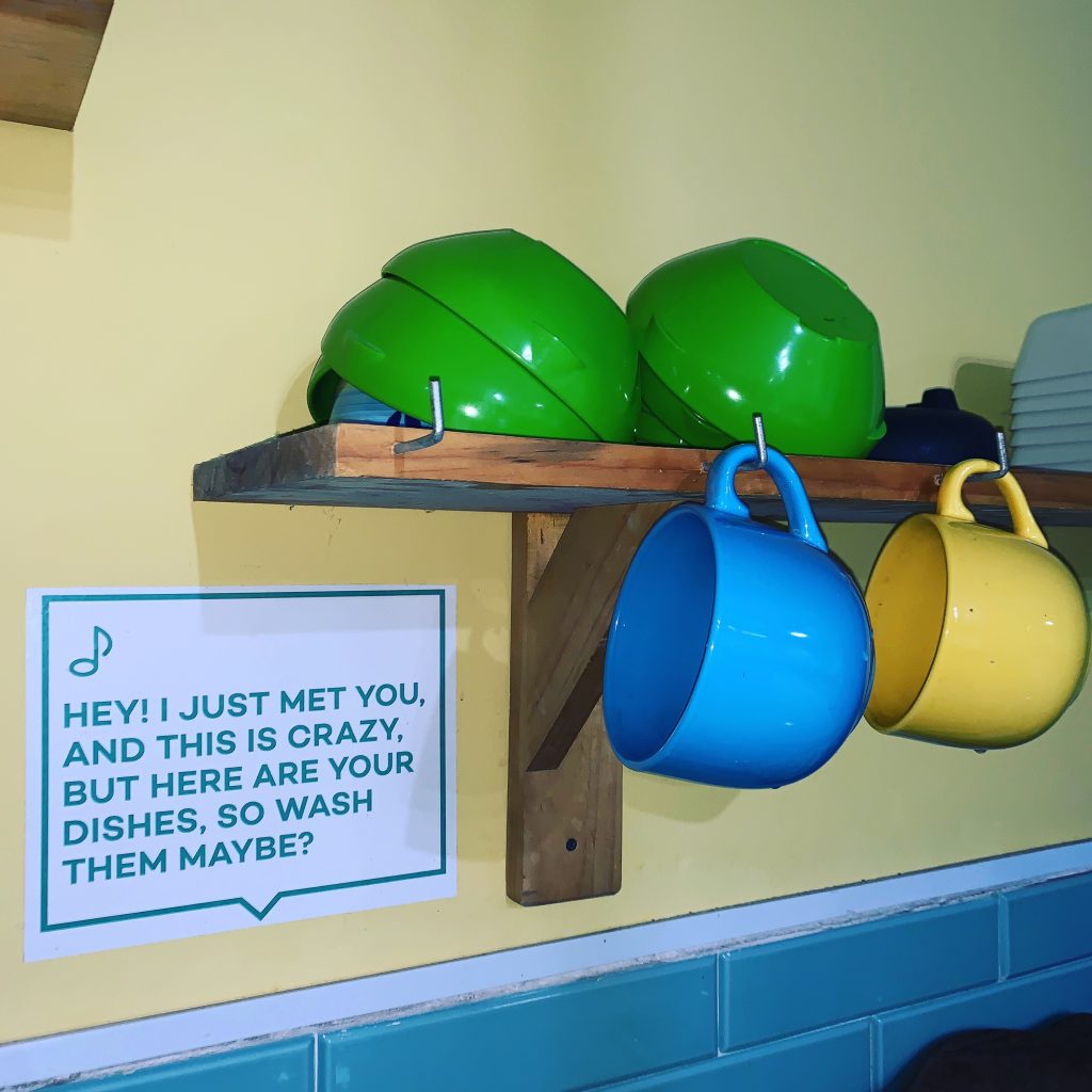 a shelf with cups and mugs on it