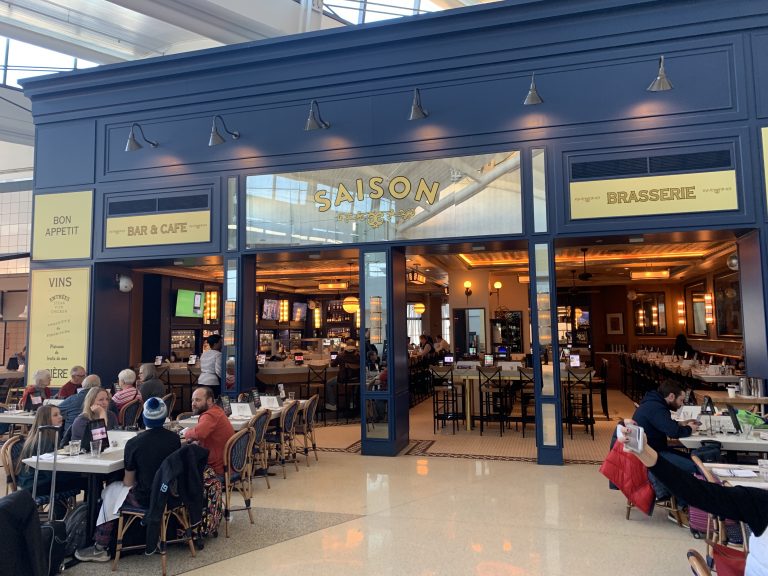 a group of people sitting at tables in a restaurant