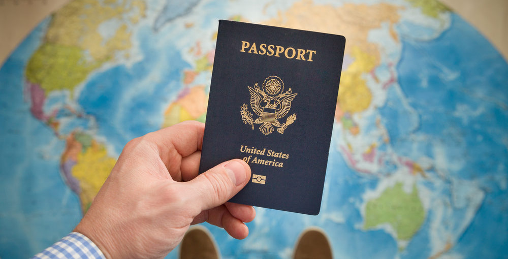 a hand holding a passport