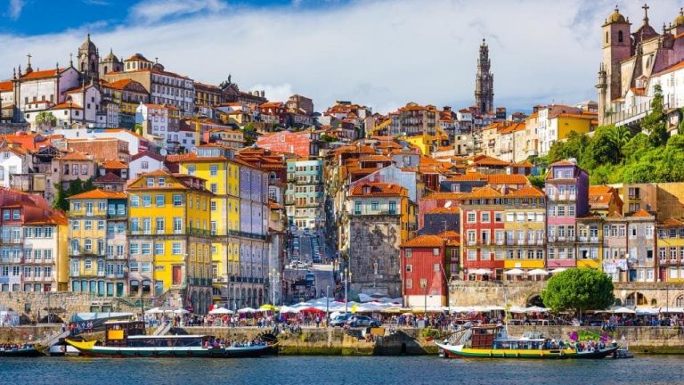 a city with many colorful buildings and boats on the water