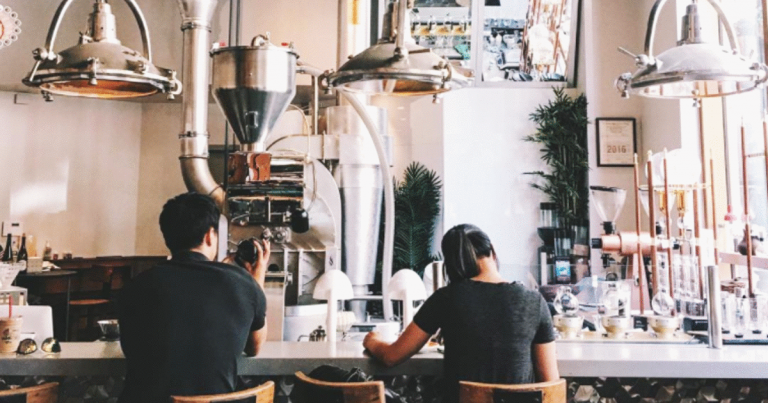 a man and woman sitting at a counter