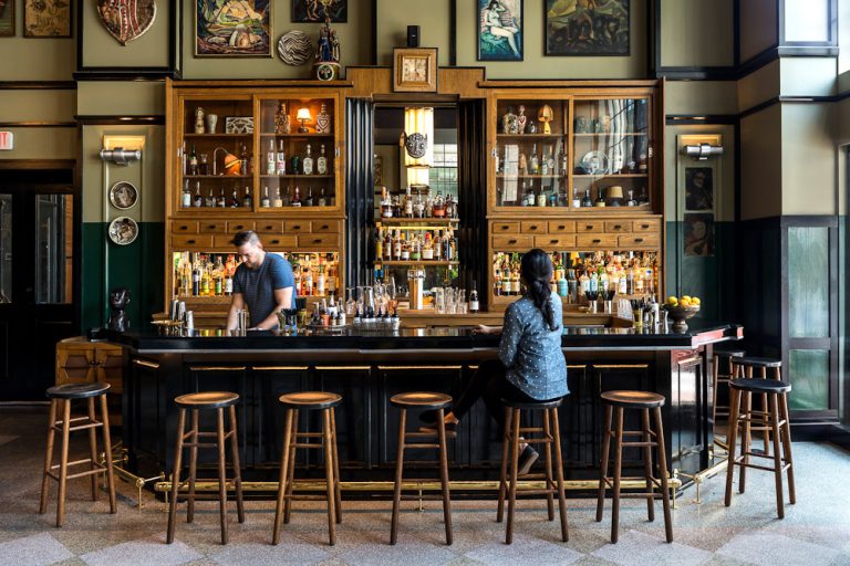 a man and woman sitting at a bar