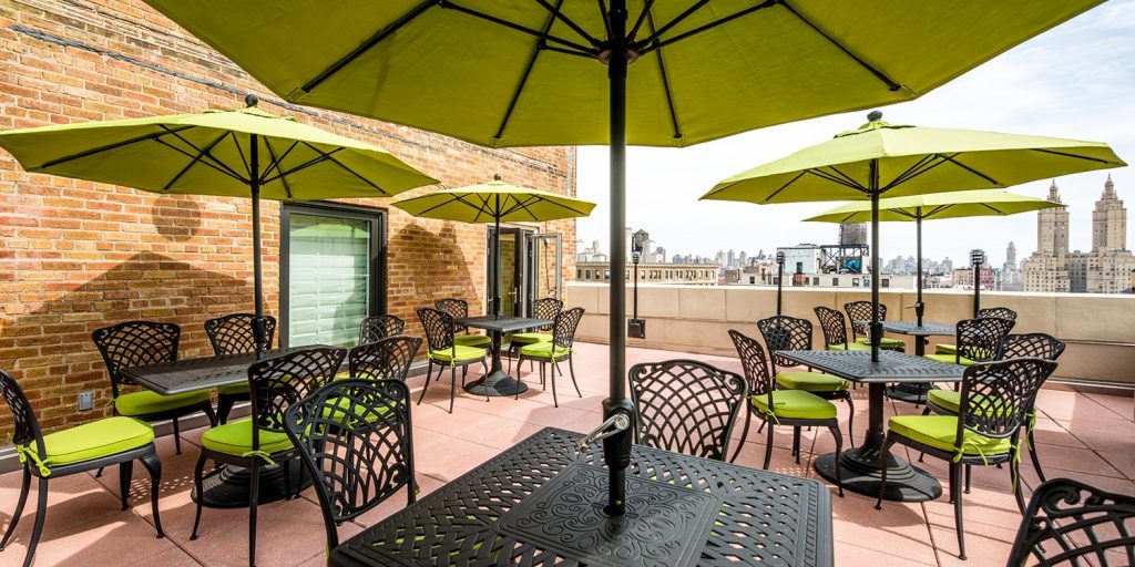 a patio with umbrellas and tables