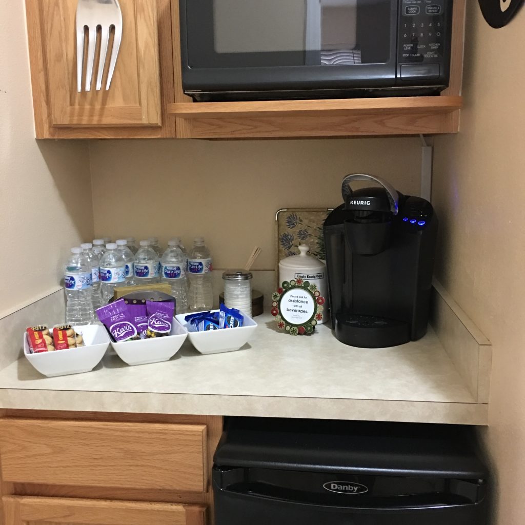a kitchen counter with a microwave and food items