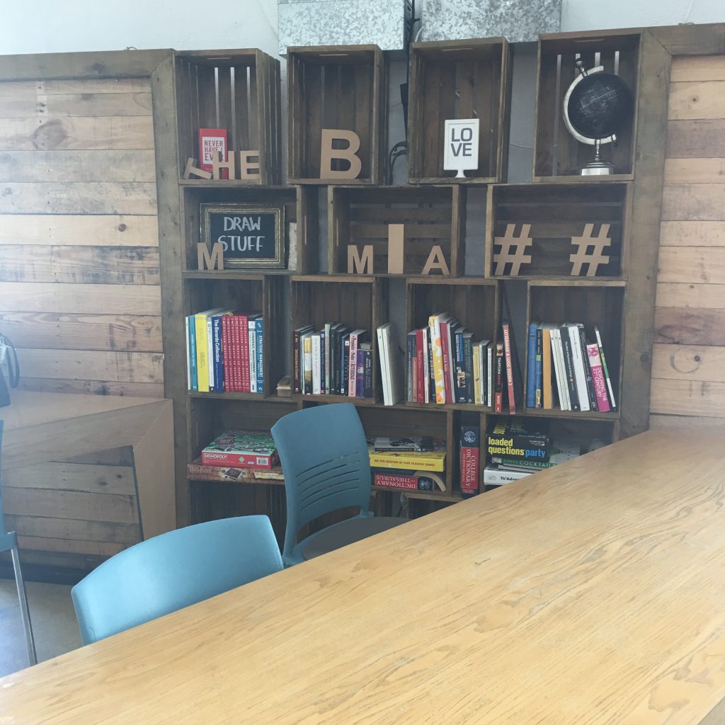 a wooden shelves with books and a table