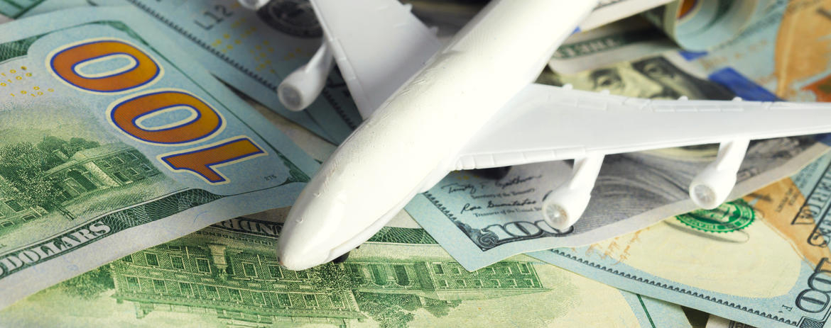 a model airplane on top of money