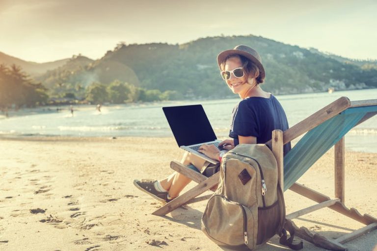 a woman sitting in a chair with a laptop on her lap