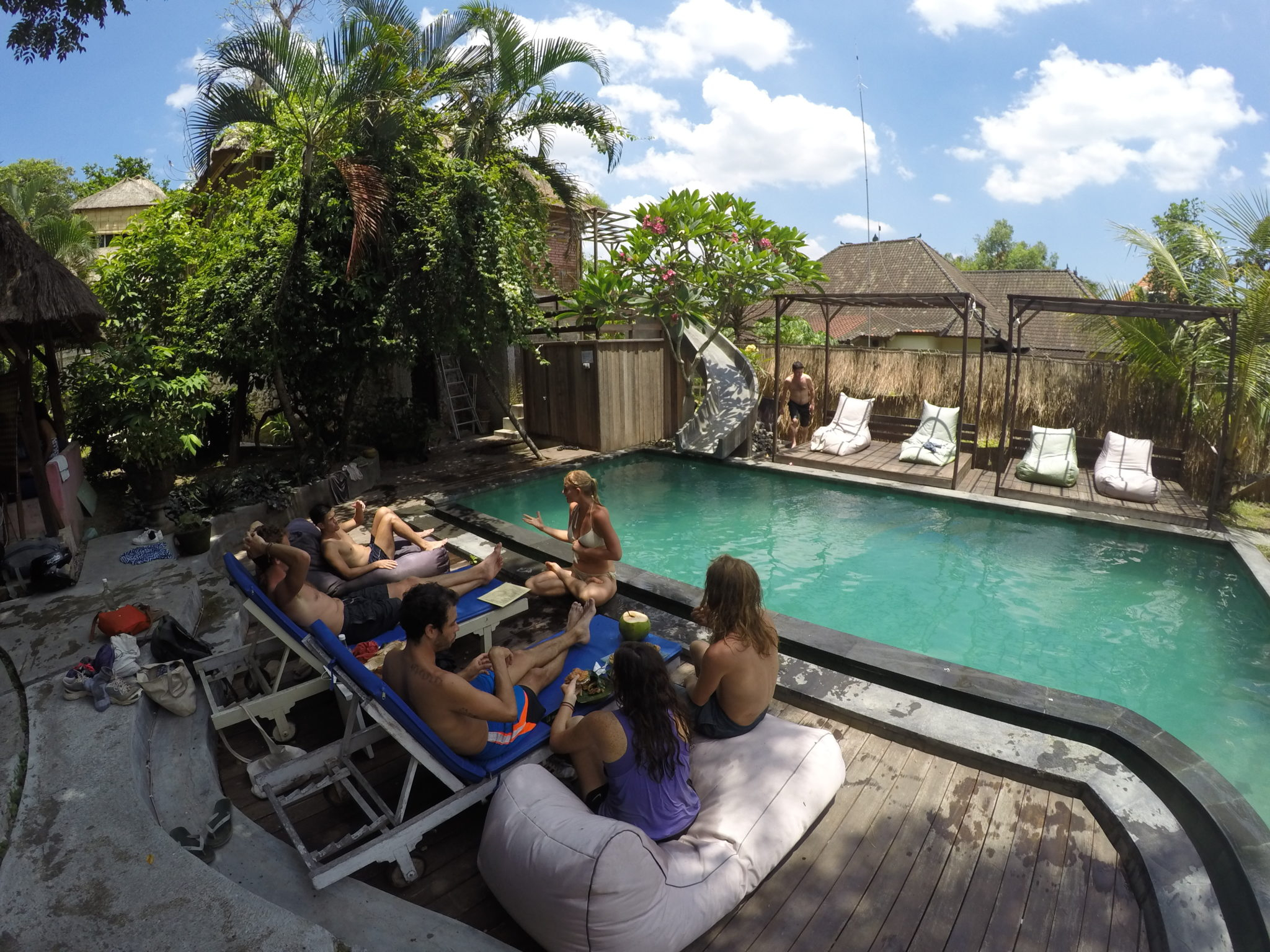 a group of people sitting around a pool