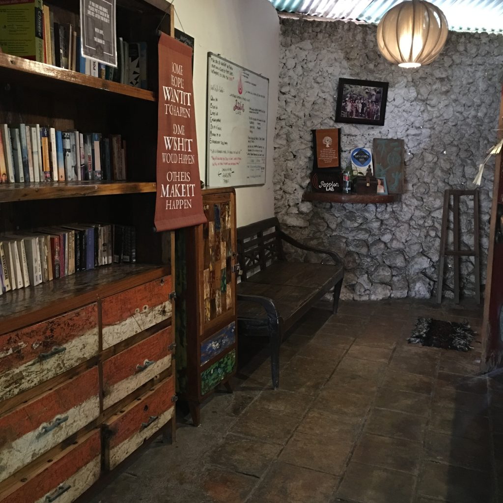 a room with a book shelf and a bench