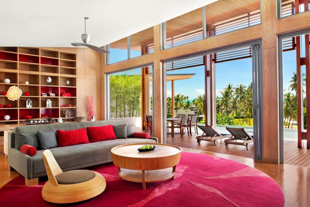 a living room with a red rug and a couch