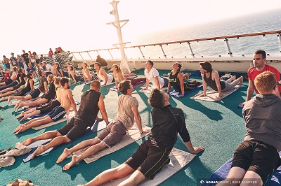 a group of people on mats on a deck of a ship