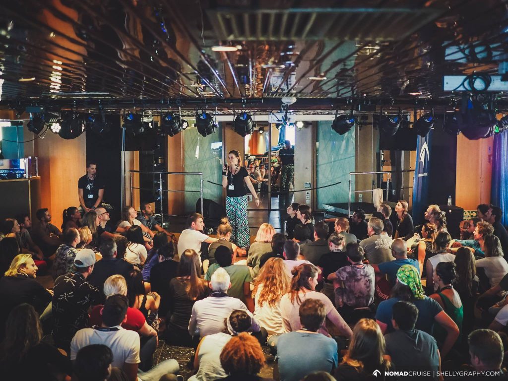 a woman on stage with a crowd of people