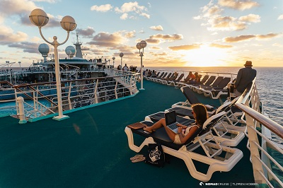 a woman sitting on a deck chair on a cruise ship