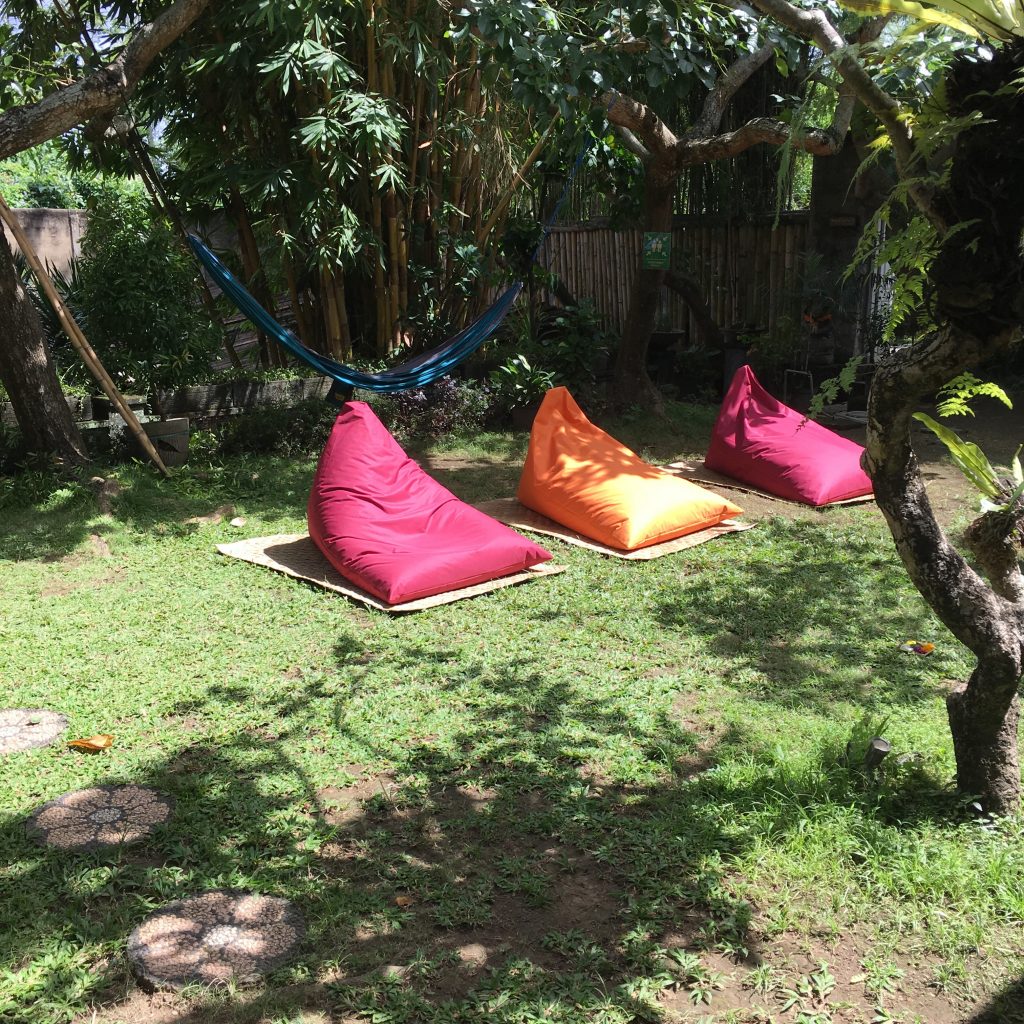 a group of bean bags on grass under a tree