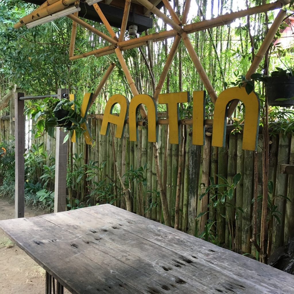 a wooden table with a sign over it