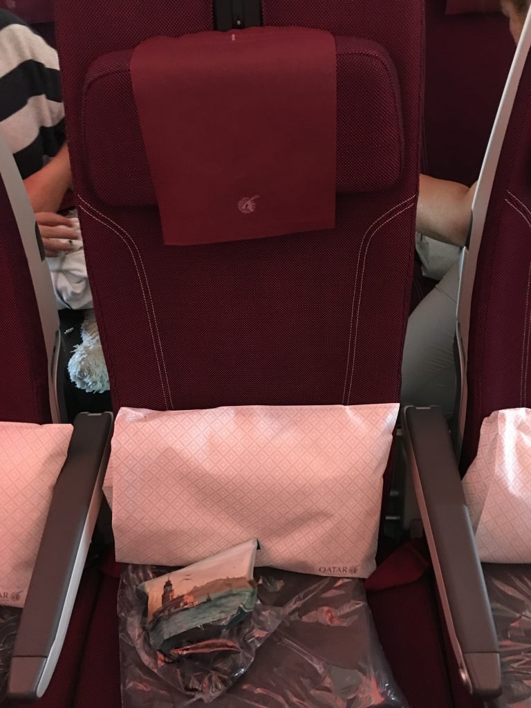 a seat with a red pillow