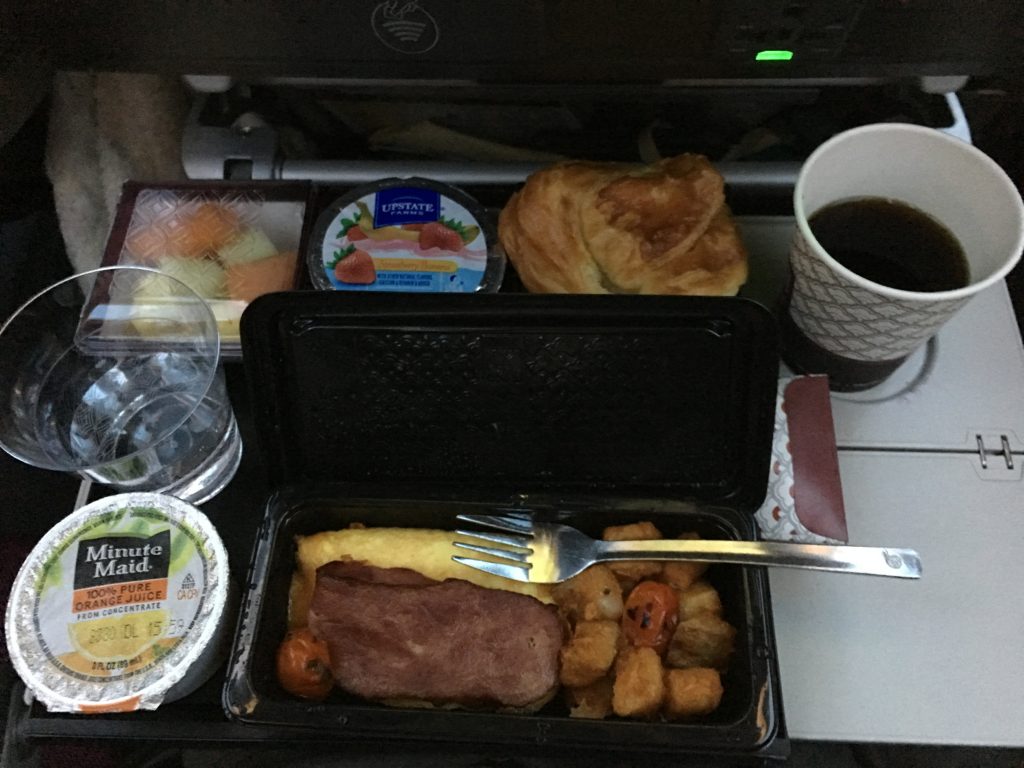 a tray of food and a cup of coffee