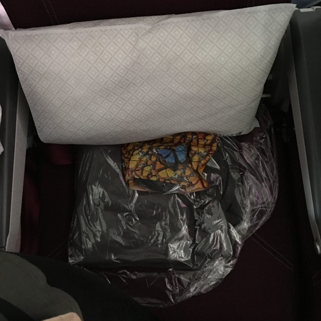 a pillow and a plastic bag on a seat