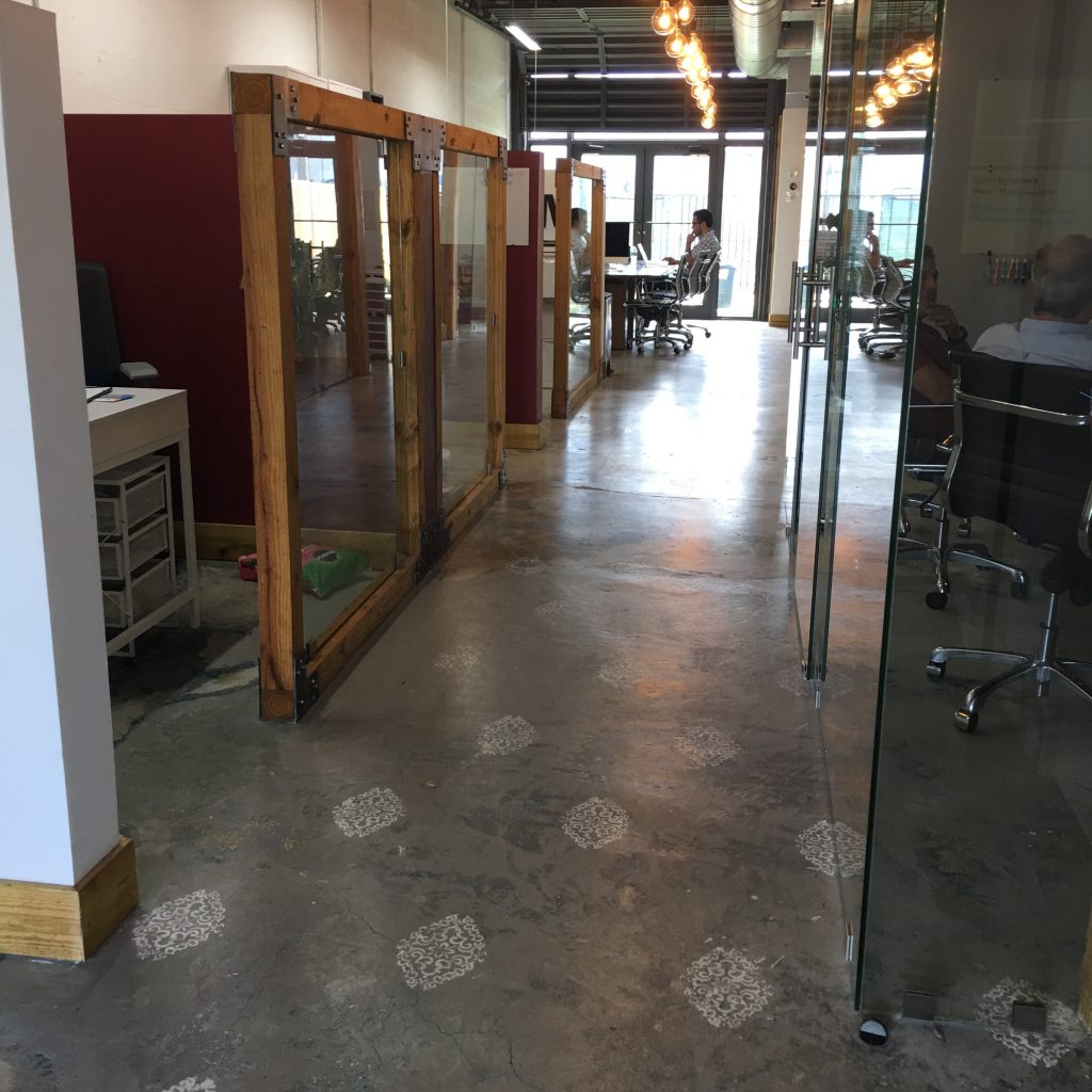 a room with glass walls and a desk