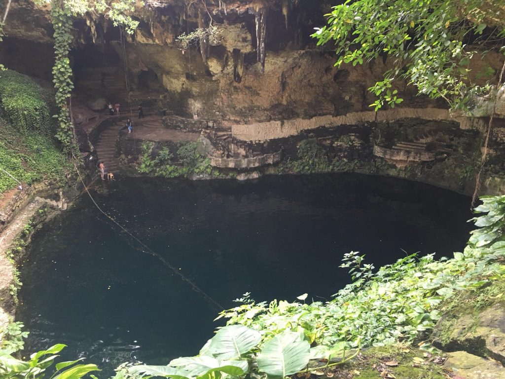 a cave with a lake and people in it