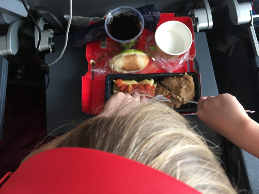 a person eating food on a tray