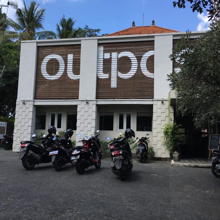 a group of motorcycles parked outside of a building