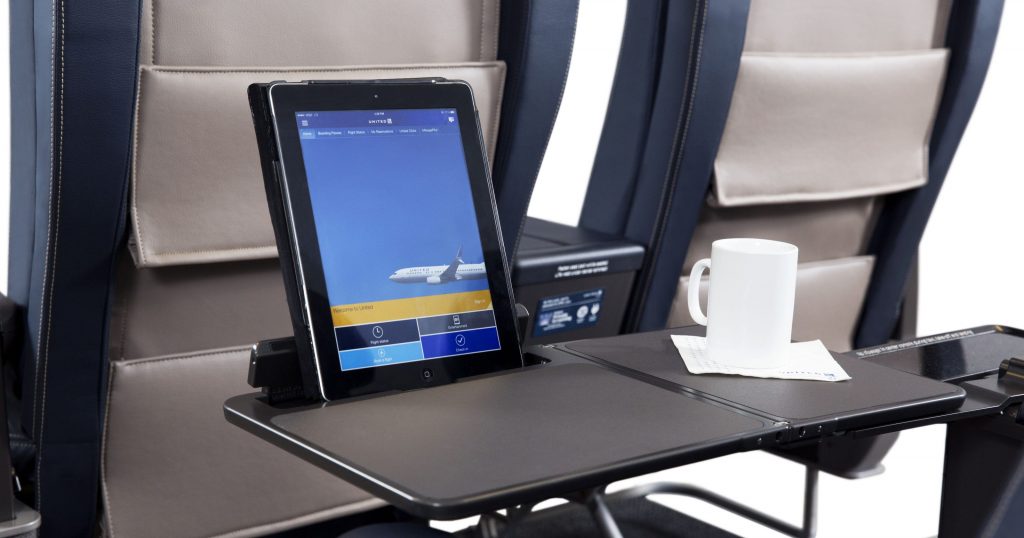 a tablet on a table in an airplane