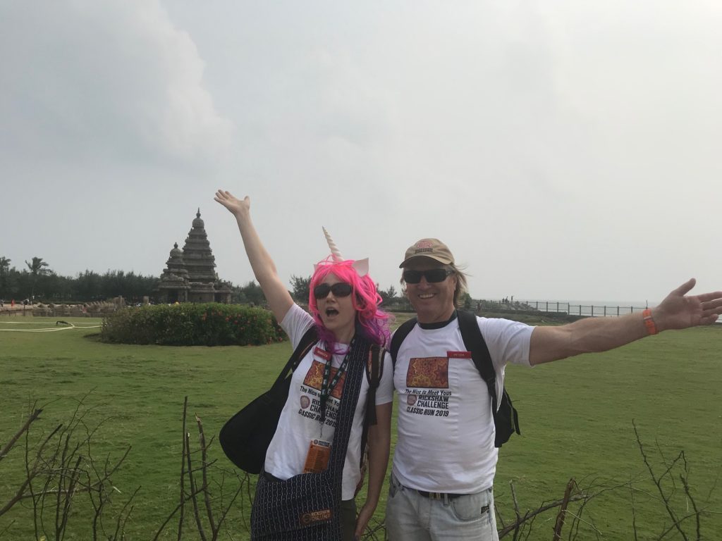 a man and woman with pink hair and a unicorn horn posing for a picture