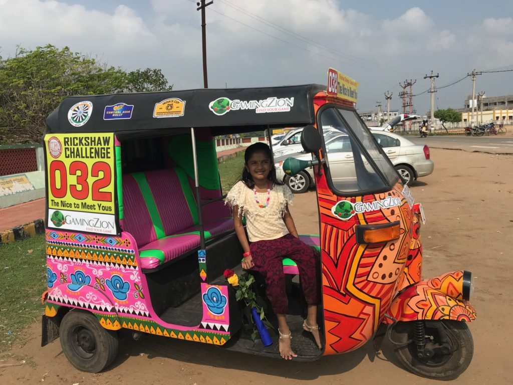 a girl sitting in a colorful vehicle