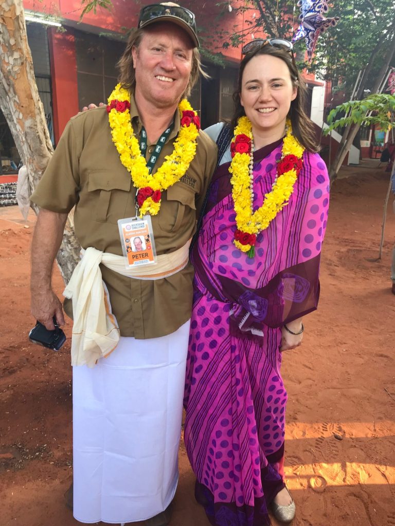 a man and woman wearing flower garlands