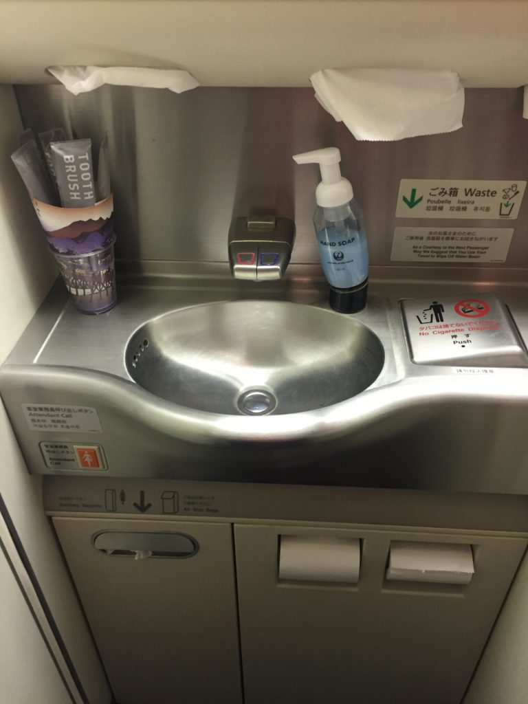 a sink with soap and toothpaste on it