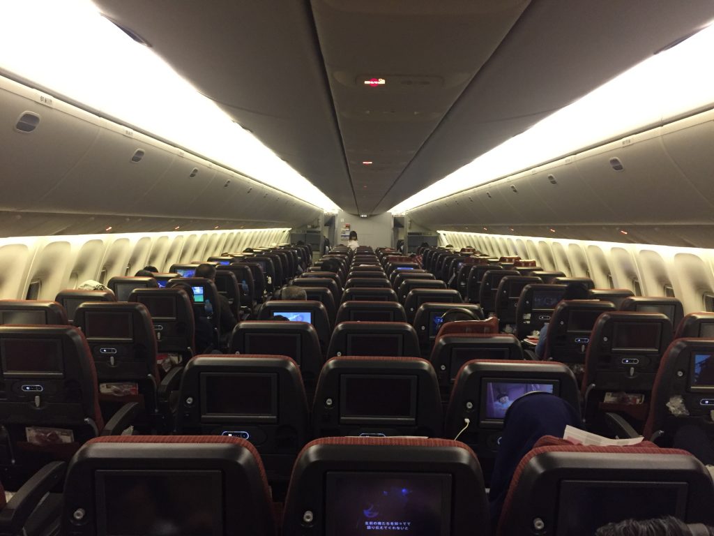 an airplane with rows of seats and monitors