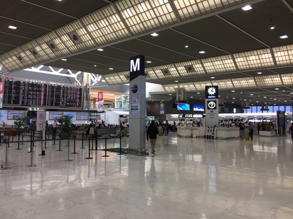 a large airport terminal with people walking