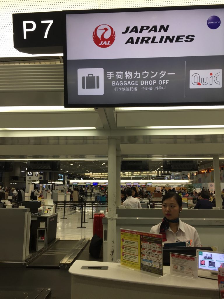 a woman standing behind a sign