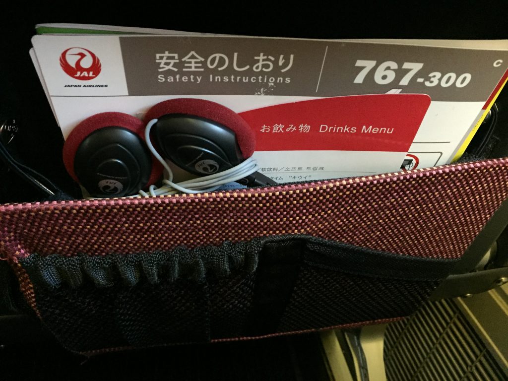 a bag with earphones and a card in it