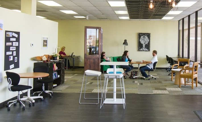 a group of people sitting at a table in a room