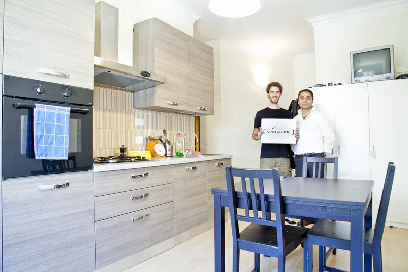two men standing in a kitchen